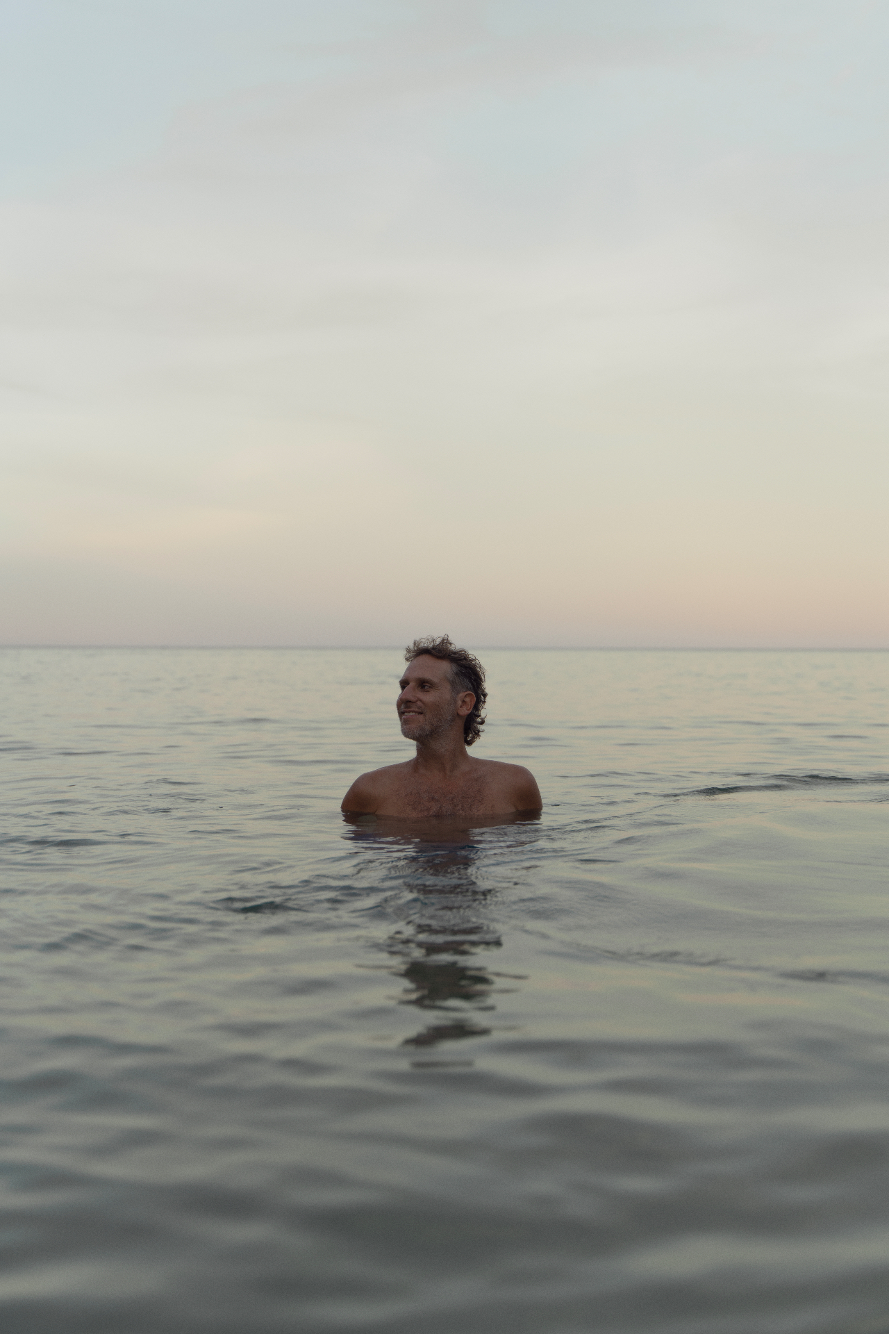 Noam Chadash in the sea at dusk
